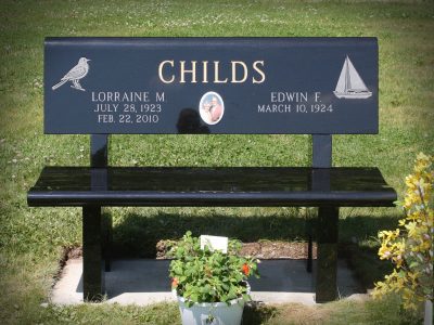 Black Granite Memorial Bench Childs Memorial with Gold Lithochrome and sailboat carving along with porcelain photo of couple