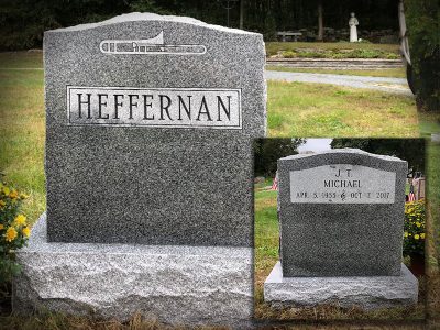 Barre Gray Granite Upright Monument Heffernan Memorial with Trumpet carving and Symbolic Dash of Music Note